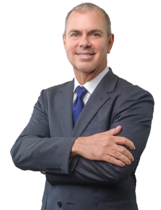 Professional man in a suit smiling with arms crossed.