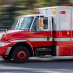 Red and white ambulance in motion.
