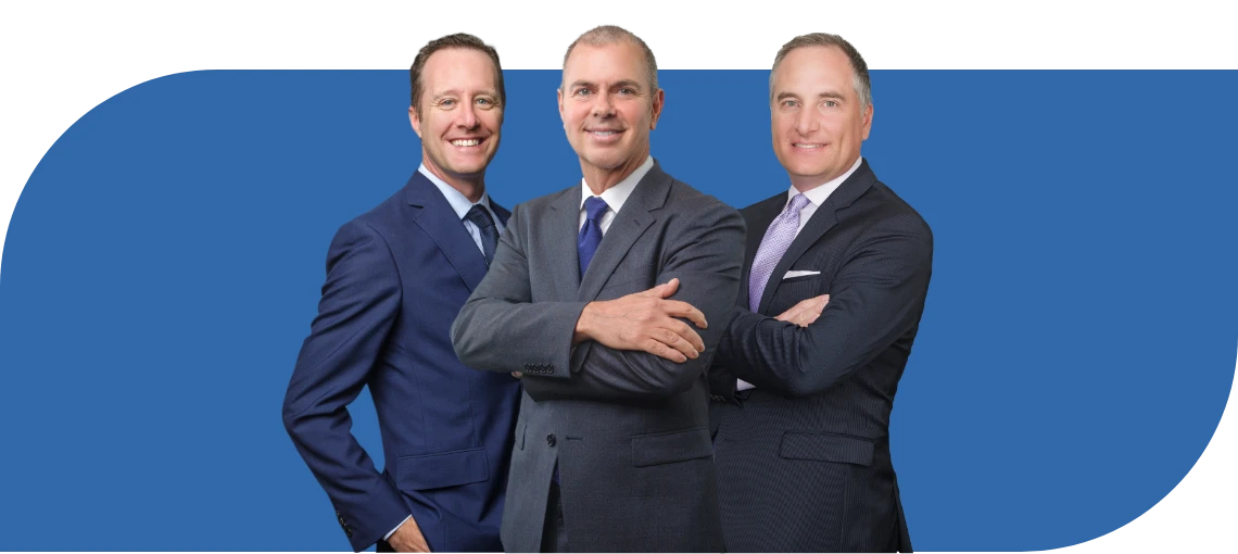 Three business professionals posing together against a blue background.
