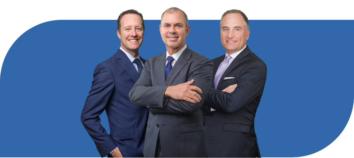 Three business professionals posing together against a blue background.