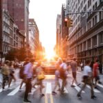 Busy pedestrians crossing marked crosswalk in urban Texas intersection demonstrating pedestrian right-of-way laws