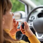 Woman vaping marijuana in car demonstrating illegal driving under influence behavior in Texas