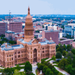 Aerial view of a large historical building surrounded by cityscape.