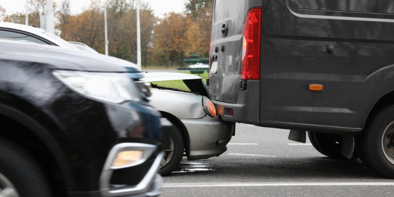 Car rear ends a van and get its hood crushed underneath the van