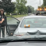 A police officer speaks with a man involved in a drugged driving accident.