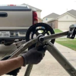 A man works on a manufacturing defect in his garage.