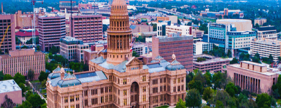 Aerial view of a large historical building surrounded by cityscape.