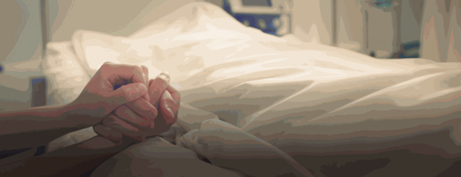 Hands holding each other over a bed with white sheets.