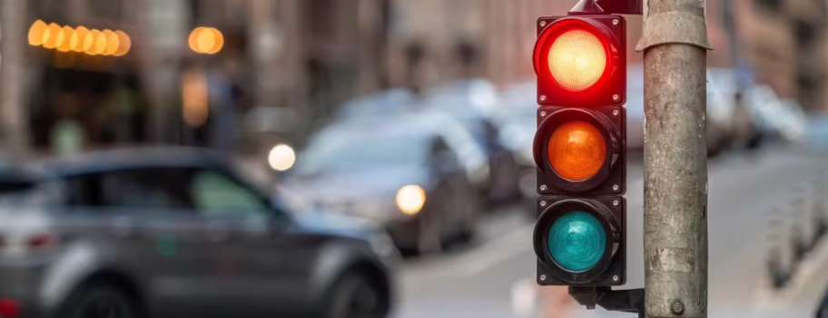 Traffic light showing red signal at busy Texas intersection where right turn on red laws apply